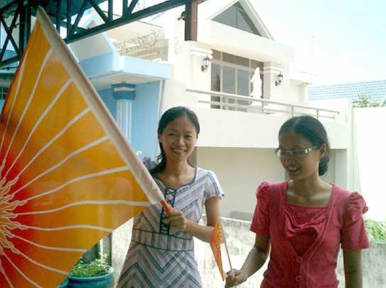 10 Vietnam.jpeg - 19 January 2011Vietnam: The two Vietnamese teachers of the Transcendental Meditation Programme raise the Flag of Invincbility during a special celebration on October